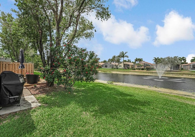 view of yard featuring a water view and a residential view