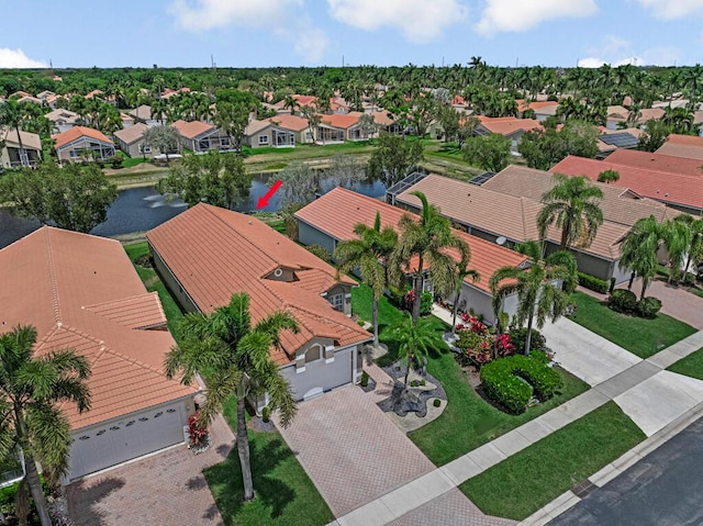 drone / aerial view with a water view and a residential view