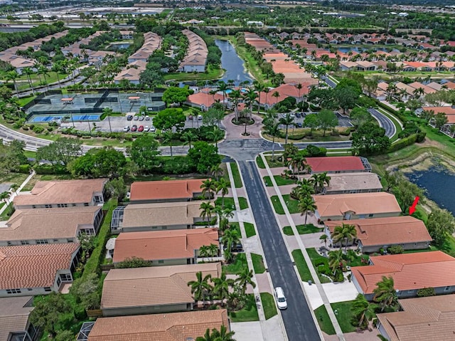 drone / aerial view with a residential view and a water view