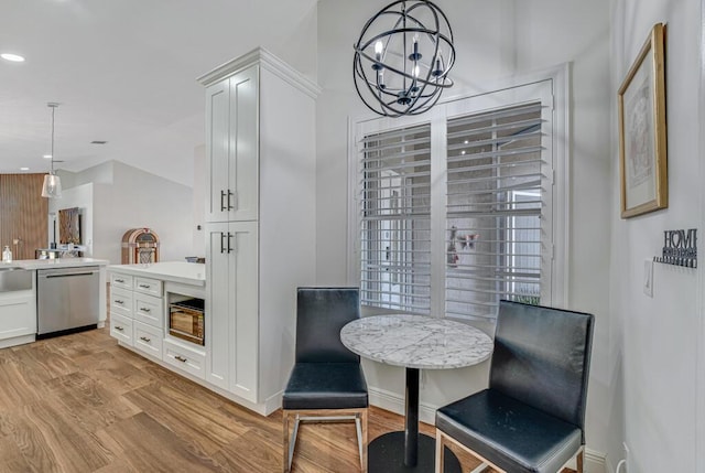dining space with recessed lighting, an inviting chandelier, and light wood-type flooring