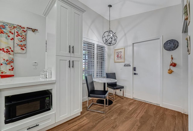 foyer entrance with a chandelier and wood finished floors
