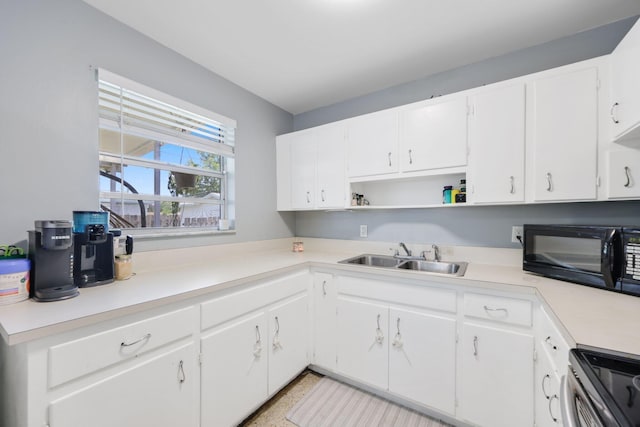 2136 W Carrol Cir, West Palm Beach, FL 33415 - kitchen featuring black microwave, open shelves, range, a sink, and white cabinets