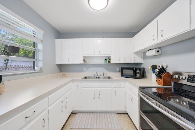 2136 W Carrol Cir, West Palm Beach, FL 33415 - kitchen with double oven range, black microwave, a sink, open shelves, and light countertops