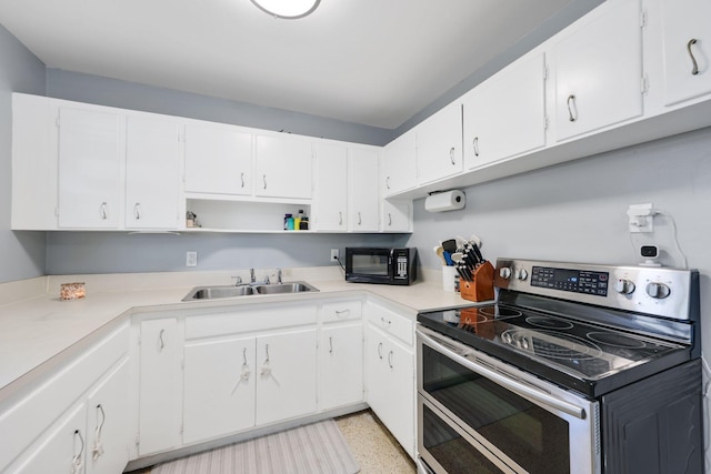 2136 W Carrol Cir, West Palm Beach, FL 33415 - kitchen with range with two ovens, a sink, black microwave, open shelves, and white cabinetry