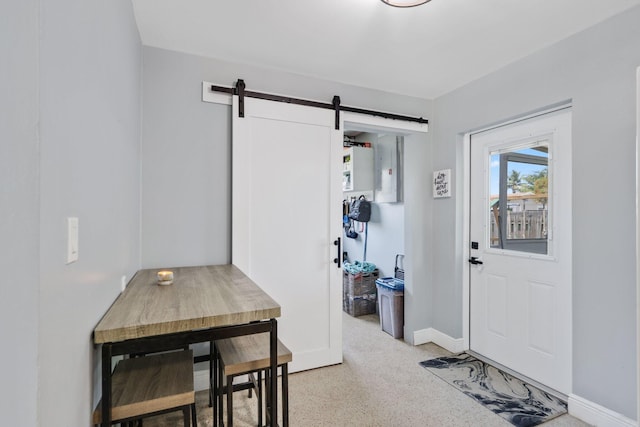 2136 W Carrol Cir, West Palm Beach, FL 33415 - foyer with a barn door, baseboards, and dark speckled floor
