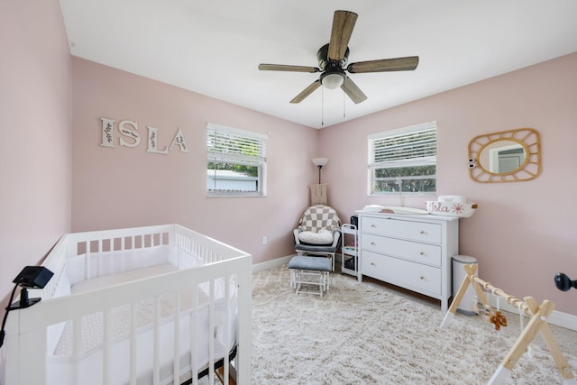 2136 W Carrol Cir, West Palm Beach, FL 33415 - bedroom with a nursery area, baseboards, carpet, and a ceiling fan