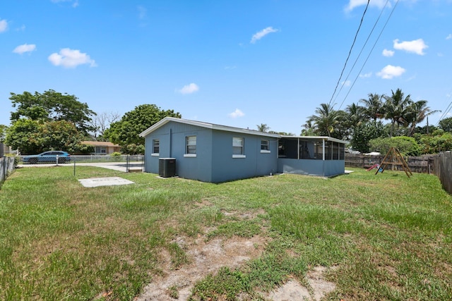 2136 W Carrol Cir, West Palm Beach, FL 33415 - rear view of property featuring a sunroom and cooling unit