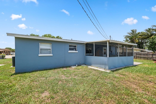 2136 W Carrol Cir, West Palm Beach, FL 33415 - rear view of house with a sunroom, stucco siding, and cooling unit