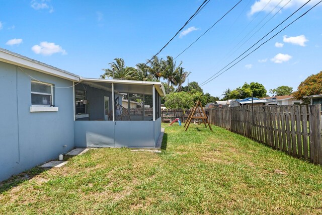 2136 W Carrol Cir, West Palm Beach, FL 33415 - view of yard featuring a sunroom