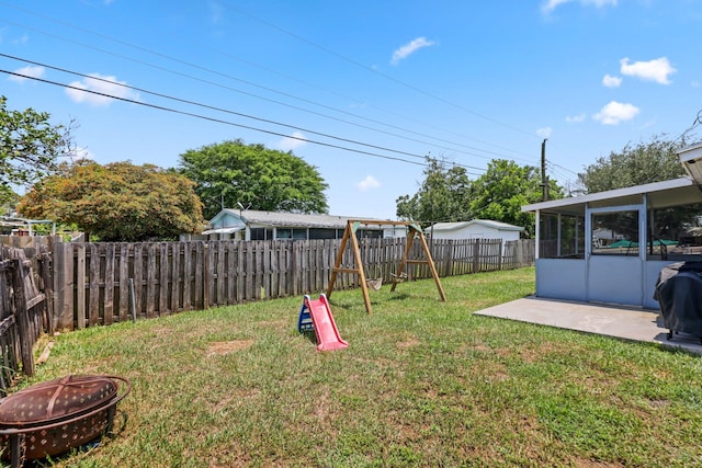 2136 W Carrol Cir, West Palm Beach, FL 33415 - view of yard with an outdoor fire pit, a patio area, and a sunroom