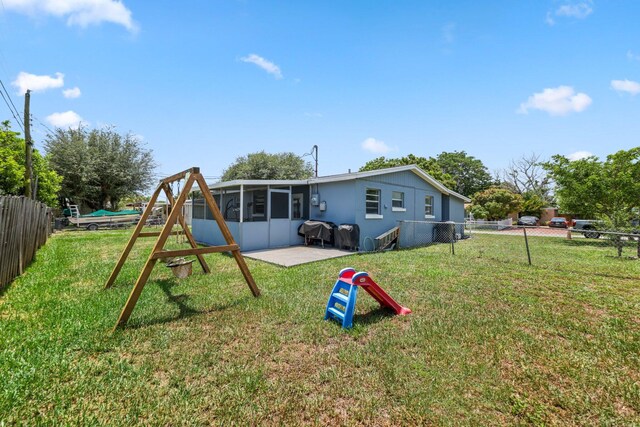 2136 W Carrol Cir, West Palm Beach, FL 33415 - back of house with a sunroom and a patio