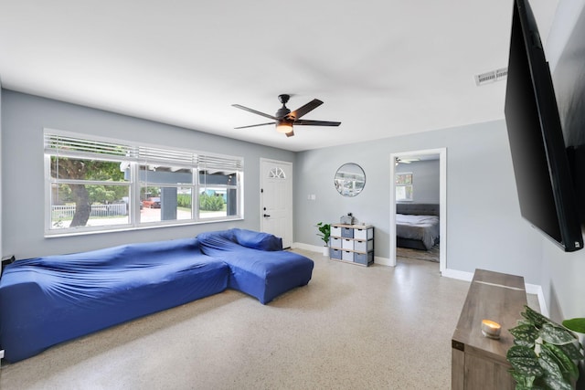2136 W Carrol Cir, West Palm Beach, FL 33415 - living room featuring ceiling fan, speckle patterned floor, and baseboards