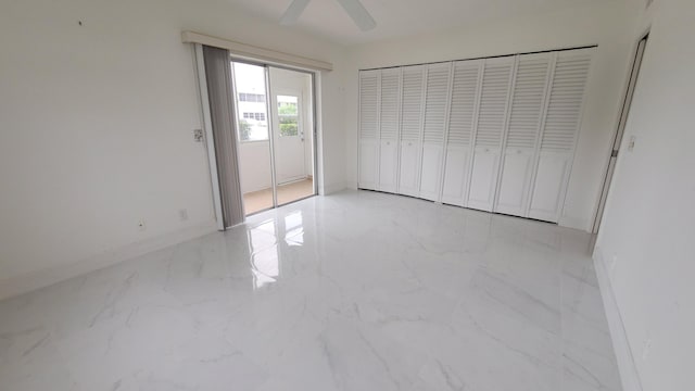 unfurnished bedroom featuring marble finish floors, baseboards, and ceiling fan