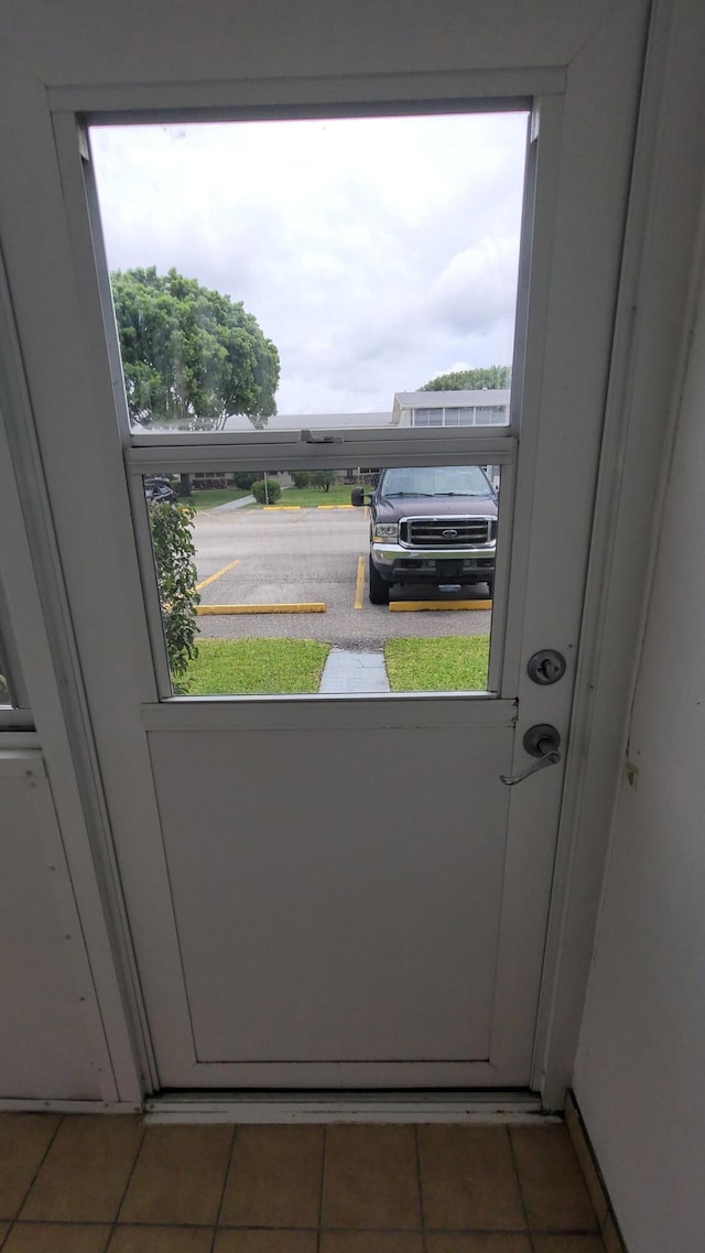 doorway to outside featuring tile patterned flooring