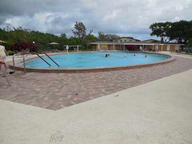 community pool with a patio area