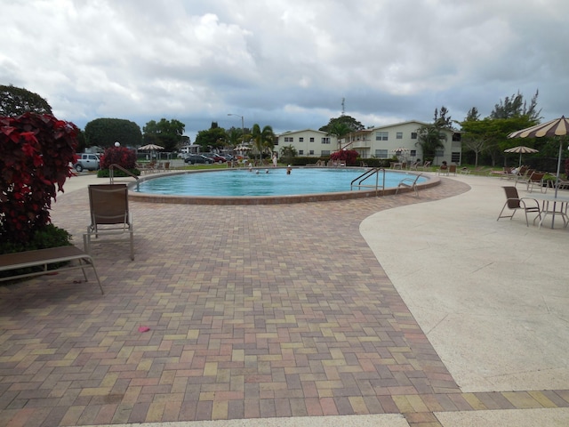 community pool with a patio area