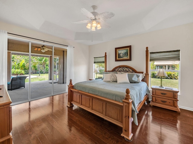 8465 Mandarin Blvd, Loxahatchee, FL 33470 - bedroom with a ceiling fan, a tray ceiling, access to exterior, and dark wood-type flooring