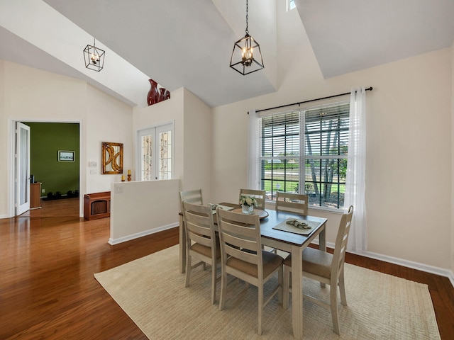 8465 Mandarin Blvd, Loxahatchee, FL 33470 - dining room featuring baseboards, dark wood-style flooring, a chandelier, and high vaulted ceiling