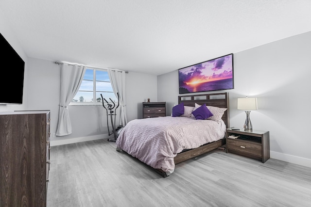 bedroom featuring baseboards and light wood-type flooring