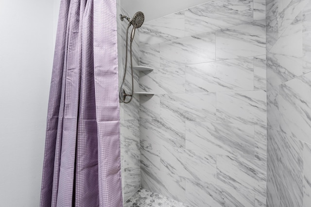 full bath with a tile shower