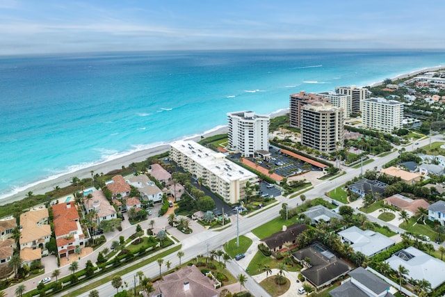 aerial view with a water view and a beach view
