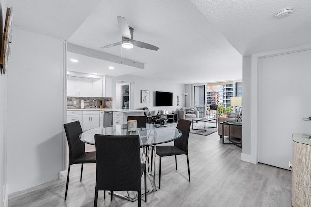 dining area featuring a ceiling fan, a textured ceiling, recessed lighting, and light wood finished floors