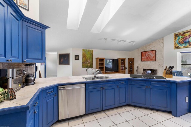 kitchen with a sink, tile counters, blue cabinetry, a peninsula, and stainless steel dishwasher