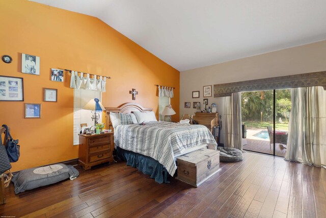 bedroom with wood-type flooring, vaulted ceiling, and access to exterior