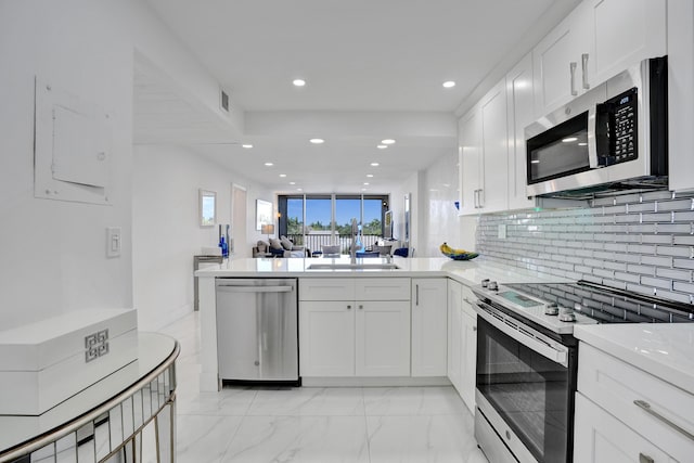 6 Royal Palm Way Unit 506, Boca Raton, FL 33432 - kitchen featuring decorative backsplash, a sink, stainless steel appliances, recessed lighting, and white cabinetry