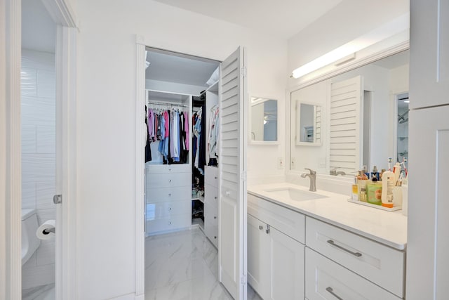 6 Royal Palm Way Unit 506, Boca Raton, FL 33432 - bathroom with a spacious closet, marble finish floor, and vanity