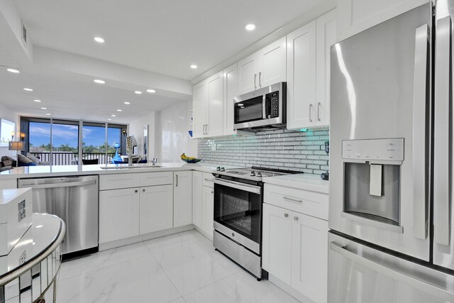 6 Royal Palm Way Unit 506, Boca Raton, FL 33432 - kitchen with a sink, stainless steel appliances, recessed lighting, white cabinetry, and tasteful backsplash