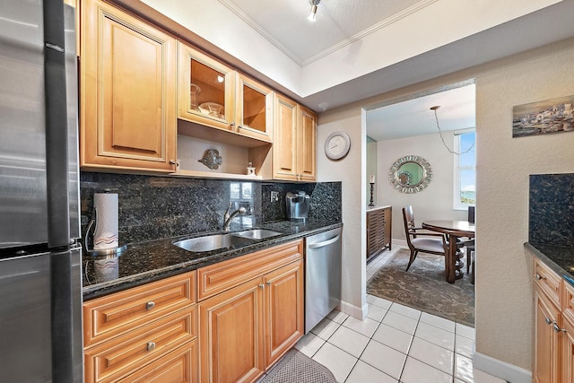 5440 N Ocean Dr Unit 202, Singer Island, FL 33404 - kitchen featuring decorative backsplash, appliances with stainless steel finishes, a sink, dark stone counters, and ornamental molding