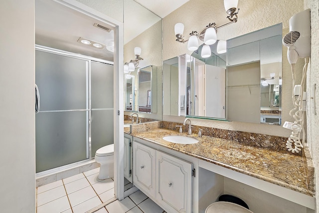 5440 N Ocean Dr Unit 202, Singer Island, FL 33404 - full bathroom featuring vanity, toilet, tile patterned floors, a shower stall, and visible vents