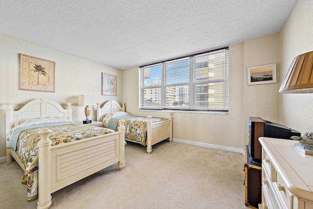 5440 N Ocean Dr Unit 202, Singer Island, FL 33404 - bedroom featuring baseboards, a textured wall, a textured ceiling, and light colored carpet