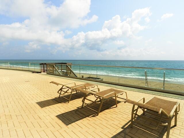 5440 N Ocean Dr Unit 202, Singer Island, FL 33404 - view of patio featuring a water view and a view of the beach