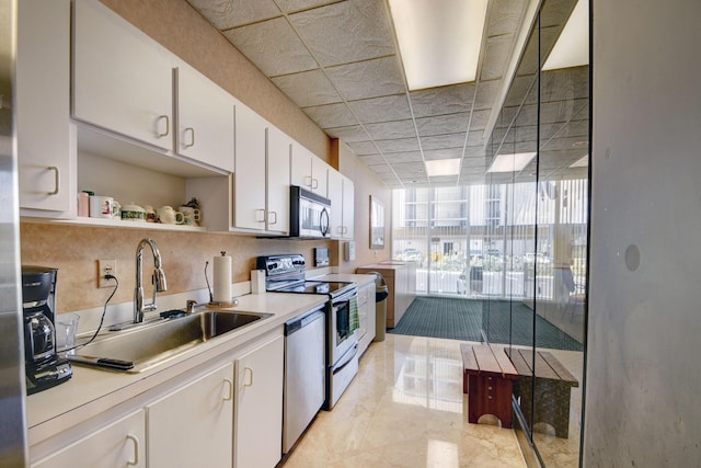 5440 N Ocean Dr Unit 202, Singer Island, FL 33404 - kitchen with white cabinets, open shelves, appliances with stainless steel finishes, a sink, and light countertops