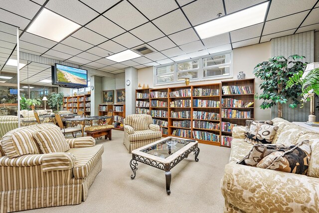 5440 N Ocean Dr Unit 202, Singer Island, FL 33404 - sitting room with visible vents, carpet, and wall of books