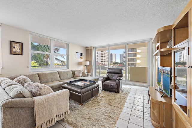 5440 N Ocean Dr Unit 202, Singer Island, FL 33404 - living room with a wall of windows, a textured ceiling, and light tile patterned flooring