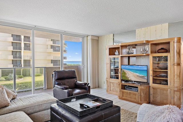 5440 N Ocean Dr Unit 202, Singer Island, FL 33404 - living area with a textured ceiling, a wall of windows, and light tile patterned floors