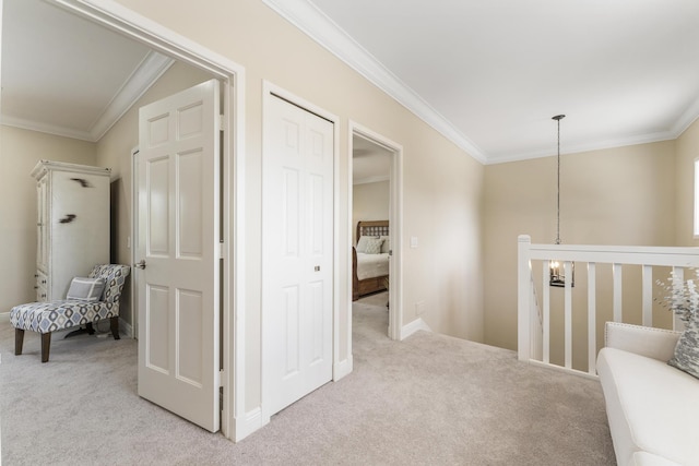 corridor featuring ornamental molding, an upstairs landing, and light colored carpet