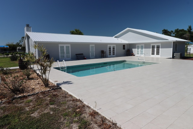 7175 NW 82nd Ct, Okeechobee, FL 34972 - outdoor pool featuring a patio, french doors, and central AC unit