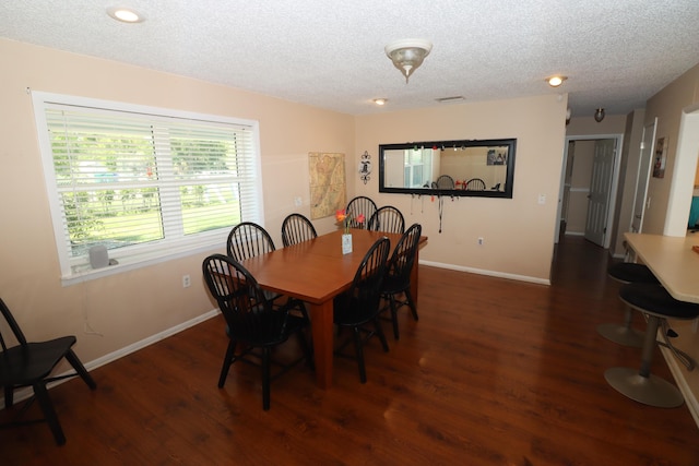 7175 NW 82nd Ct, Okeechobee, FL 34972 - dining area featuring a textured ceiling, wood finished floors, and baseboards