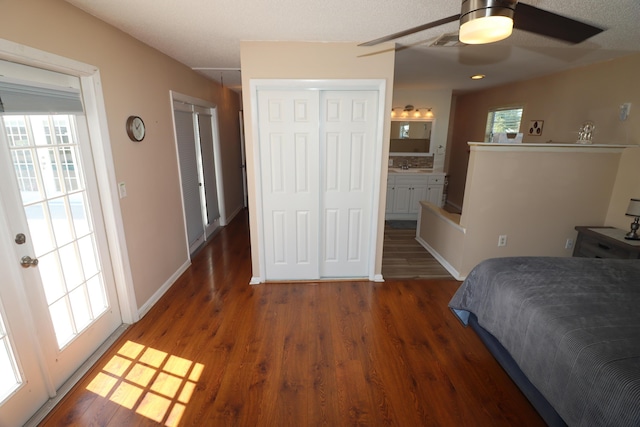 7175 NW 82nd Ct, Okeechobee, FL 34972 - bedroom featuring a sink, wood finished floors, visible vents, connected bathroom, and baseboards