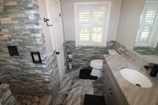 7175 NW 82nd Ct, Okeechobee, FL 34972 - full bath with tile walls, a shower stall, a wainscoted wall, and vanity