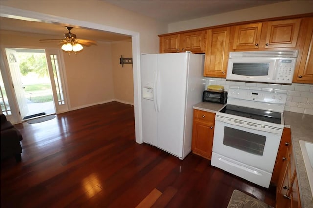 7175 NW 82nd Ct, Okeechobee, FL 34972 - kitchen featuring dark wood finished floors, decorative backsplash, brown cabinets, and white appliances