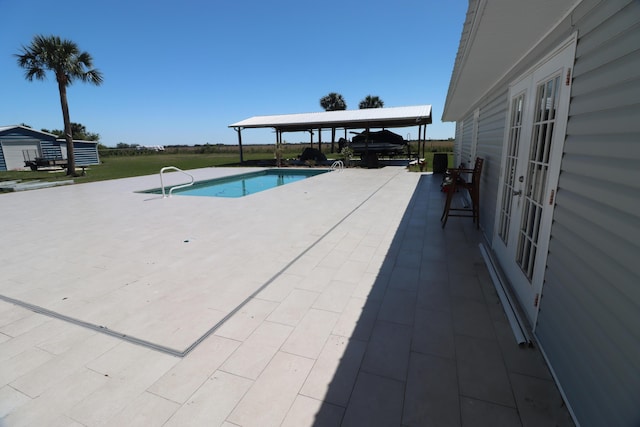 7175 NW 82nd Ct, Okeechobee, FL 34972 - outdoor pool featuring a patio and french doors