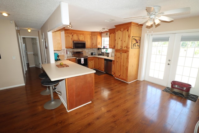 7175 NW 82nd Ct, Okeechobee, FL 34972 - kitchen with a wealth of natural light, a peninsula, appliances with stainless steel finishes, and tasteful backsplash
