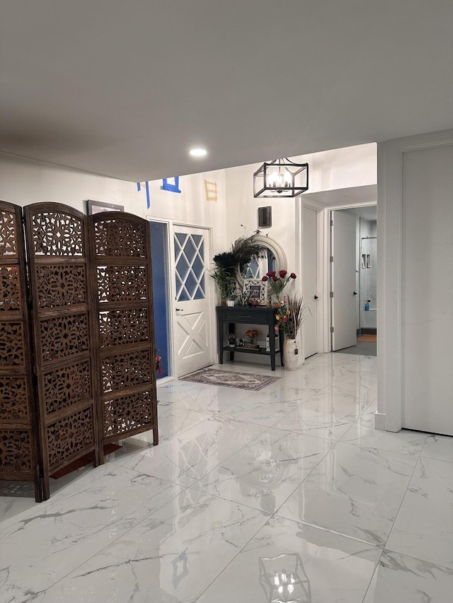 hallway with recessed lighting and marble finish floor