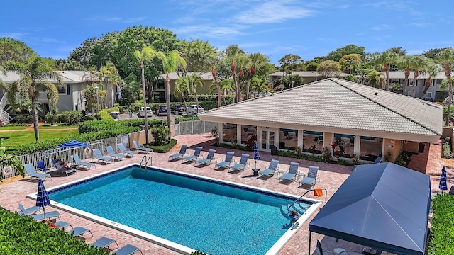 36 Stratford Ln Unit F, Boynton Beach, FL 33436 - community pool featuring a patio, fence, and a residential view