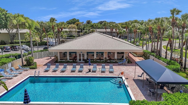 36 Stratford Ln Unit F, Boynton Beach, FL 33436 - community pool featuring a patio and fence